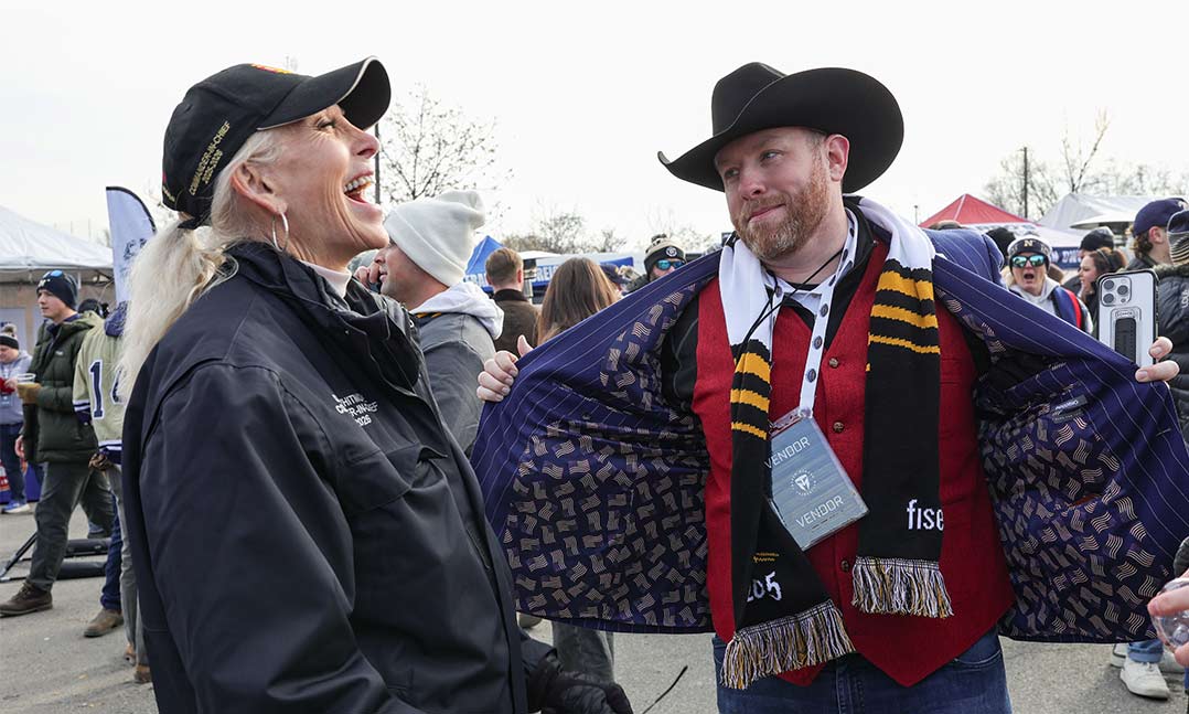 Chief Carol Whitmore laughs with fans at the Army-Navy game.