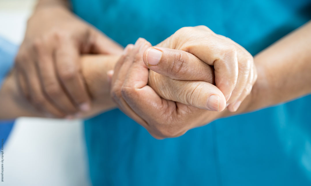 Doctor patient hands holding