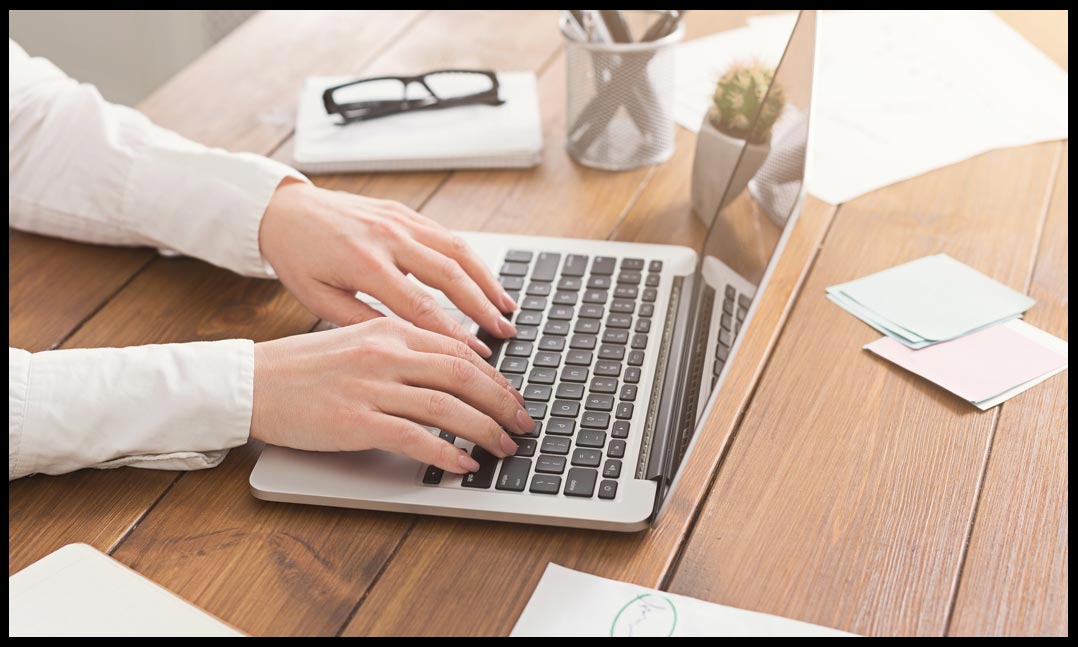 Hands typing on a keyboard