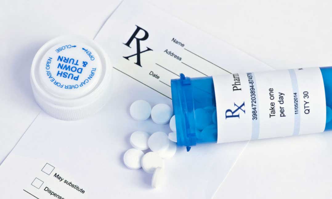 prescription, medicine bottle on its side with pills spilling out