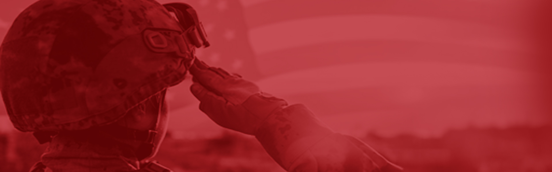 Soldier with helmet saluting flag
