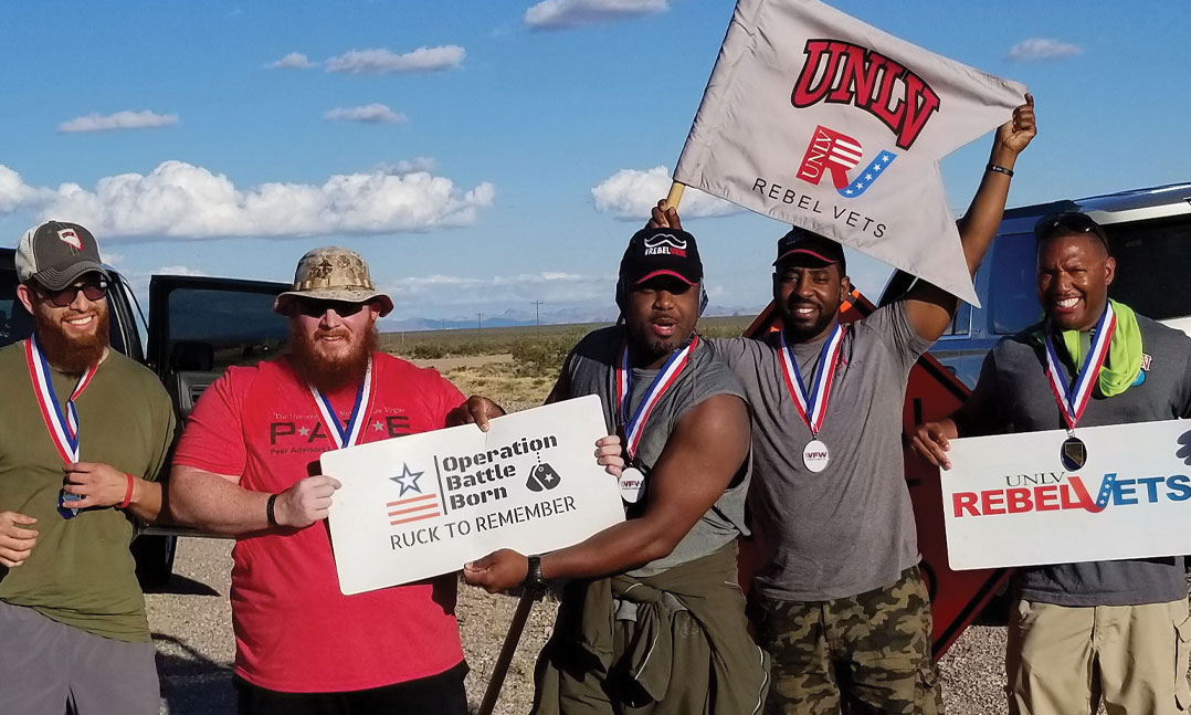 Student vets from the University of Nevada, Las Vegas pose for a photo during the 2019 Operation Battle Born rucksack march near Tonopah, Nev. Some 36 groups of four or more people, including student veterans from Nevada, hiked 10-mile stints from Carson City, Nev., to Boulder City, Nev.