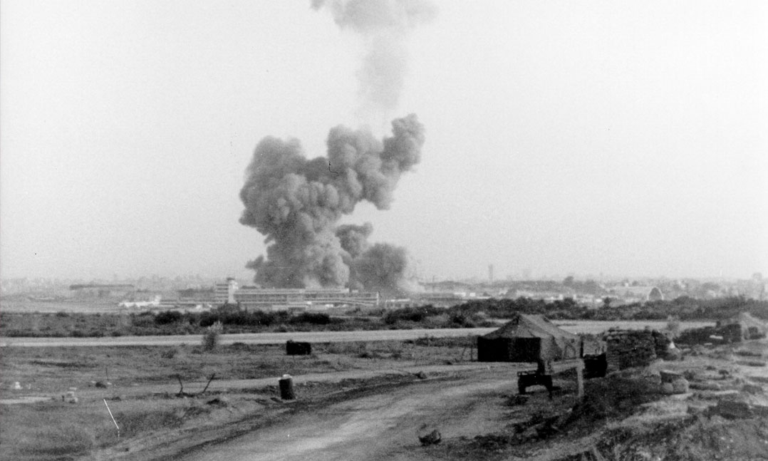 A pillar of smoke rises from the headquarters and barracks of the 1st Bn., 8th Marines, 24th Marine Amphibious Unit on Oct. 23, 1983, at the Beirut International Airport in Lebanon. This was the sight that greeted Marine helicopter crews launched from the USS Iwo Jima (LPH-2) as they flew to aid the wounded. 