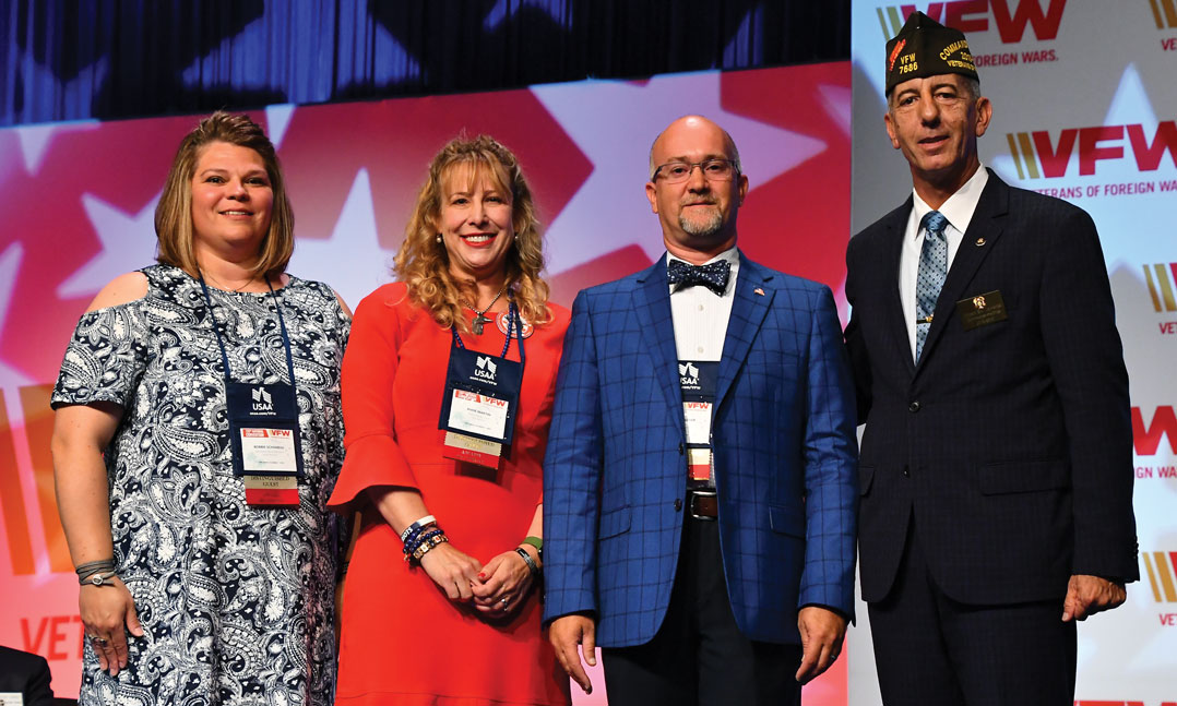 From left to right, Bobbie Schamens, Anne Martin, and Kevin Allen Wagner, celebrate their Teacher of the Year recognition alongside then-VFW Commander-in-Chief B.J. Lawrence, far right, in July at the VFW National Convention in Orlando, Fla.