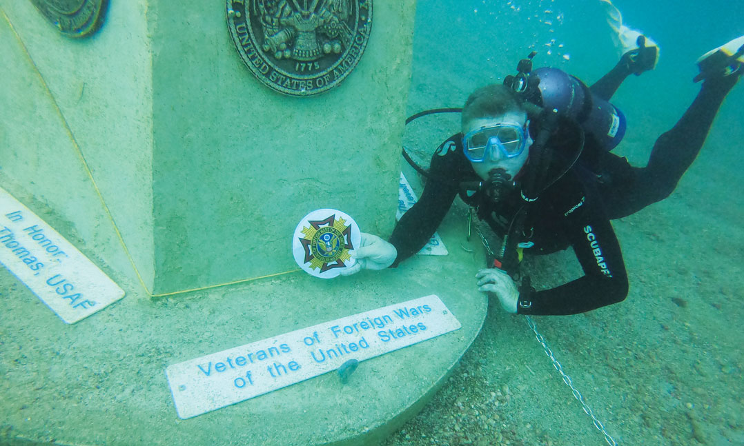 VFW Junior Vice Commander dives to place a VFW marker at the first underwater veterans memorial in Dunedin Florida