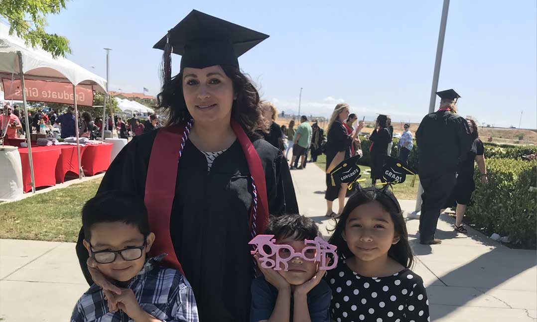 Female student veteran graduate with her children