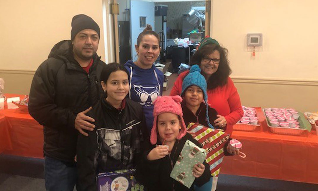 Family members receiving gifts and toys at Christmastime