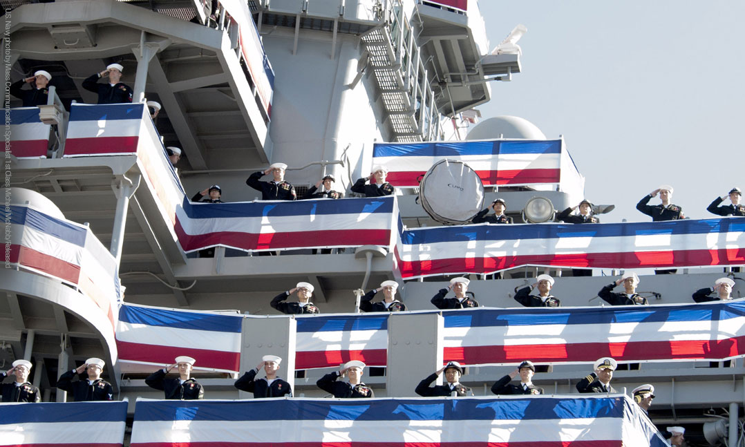 Sailors aboard a U.S. naval ship saluting