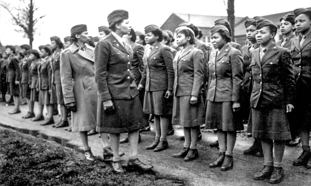 Women's Army Corps 6888th Central Postal Directory Battalion standing at attention prior to their deployment to Europe during World War II