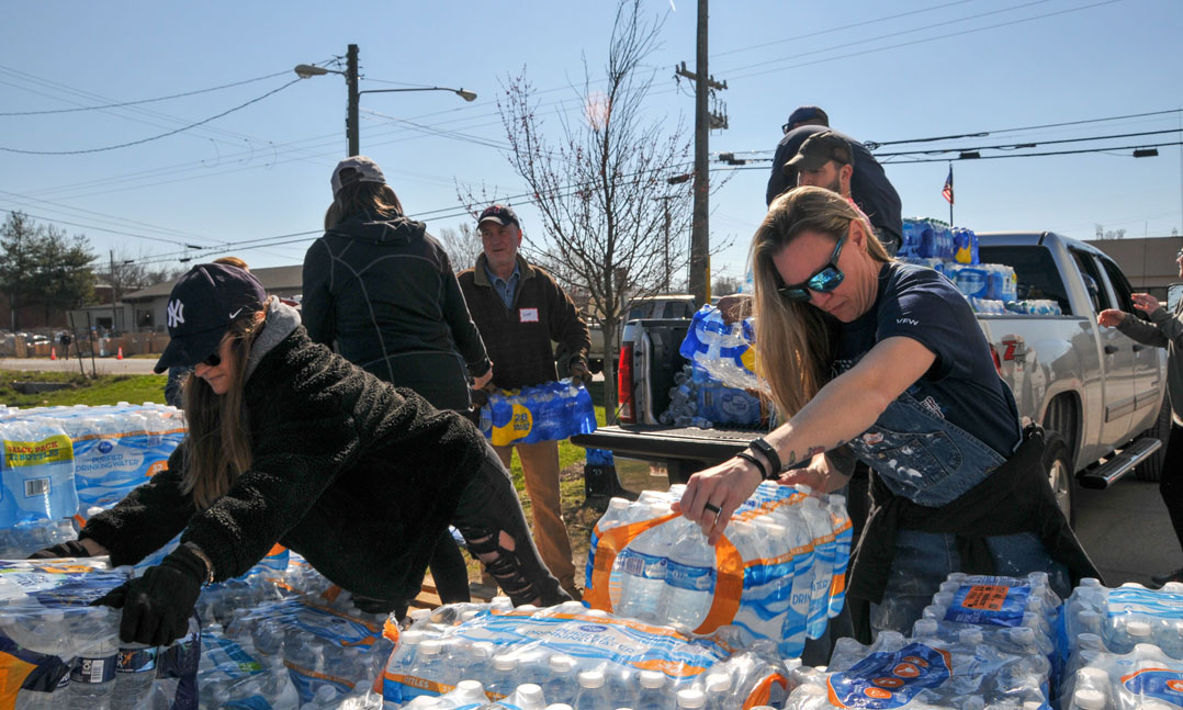 Volunteers at VFW Post 1970 in West Nashville, Tenn., load bottles of water onto a pickup to donate to victims affected by the March 3 tornado that struck the Nashville area