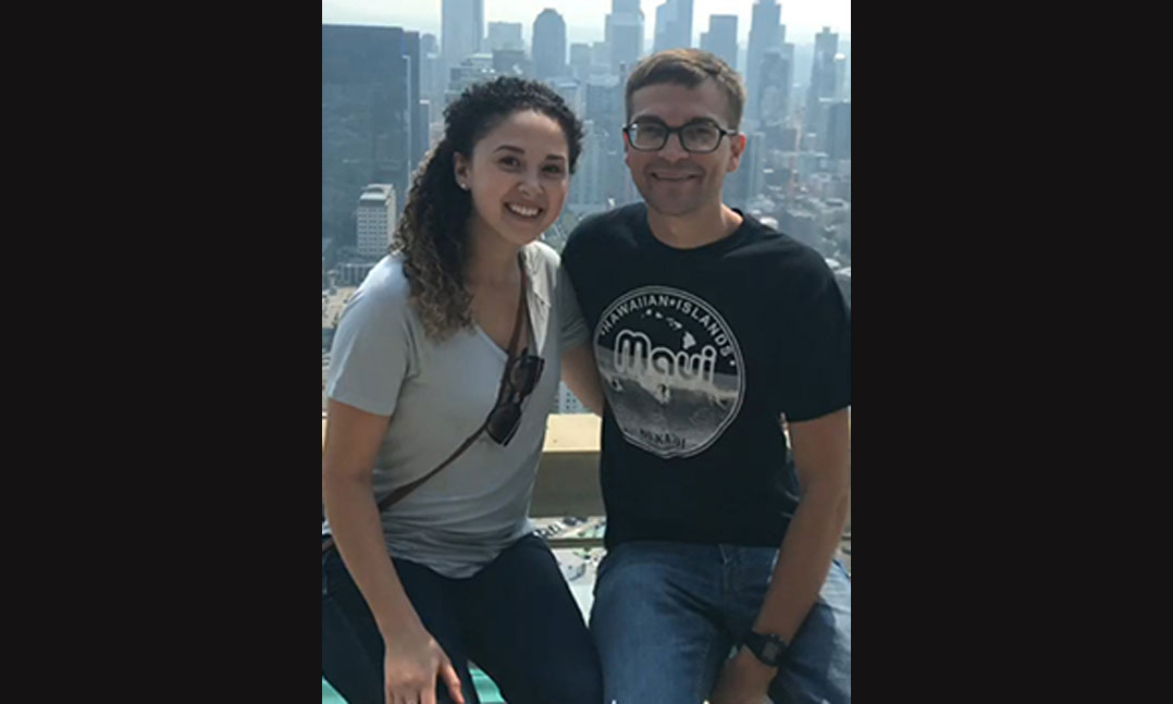 Veteran and his wife in front of a city outline