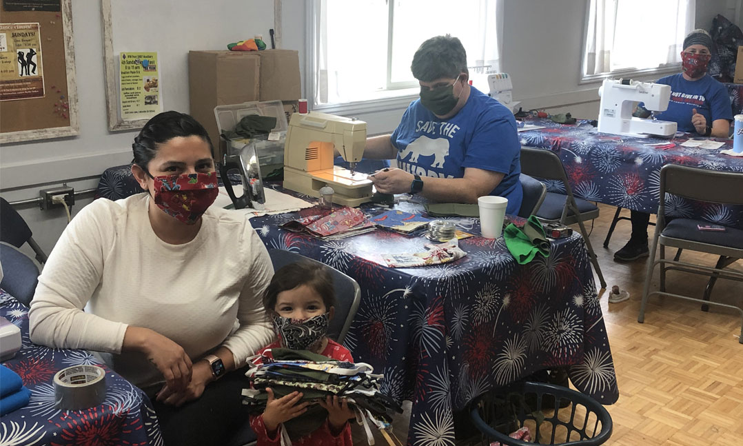 Members of a VFW Post make masks for active duty sailors