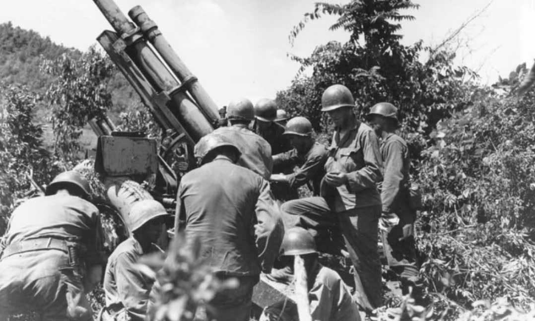 A gun crew checks their equipment near the Kum River