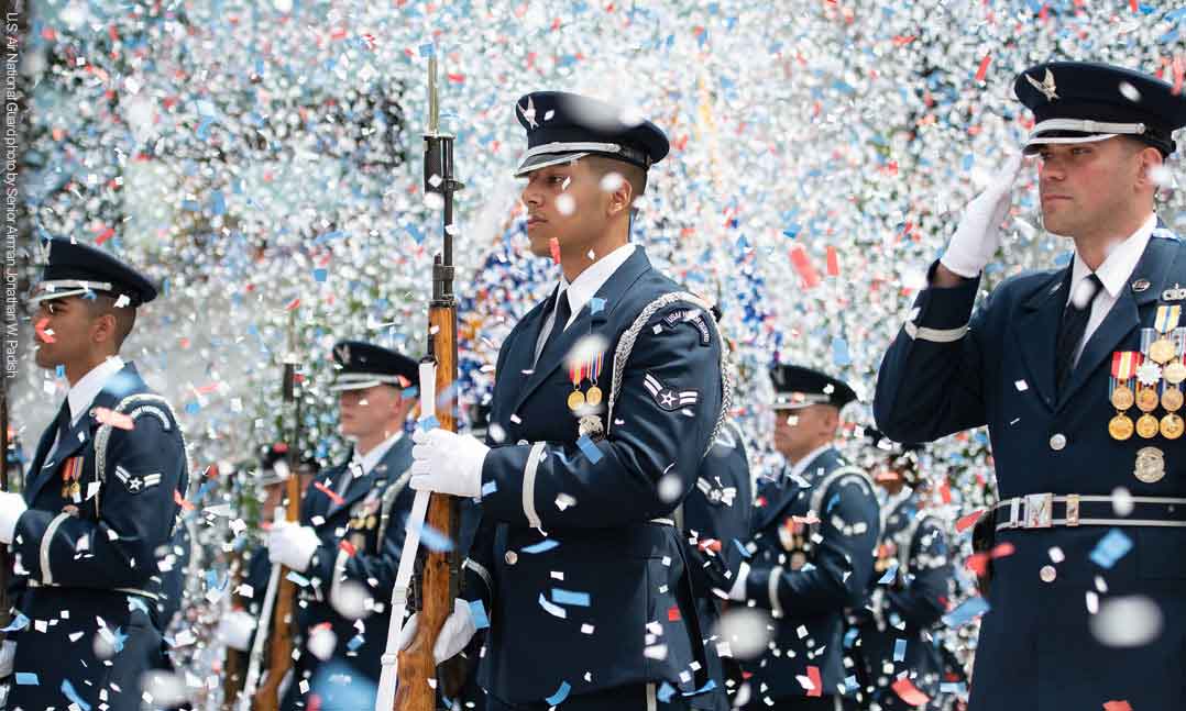 Confetti flies around members of the US Air Force in their dress blue uniforms