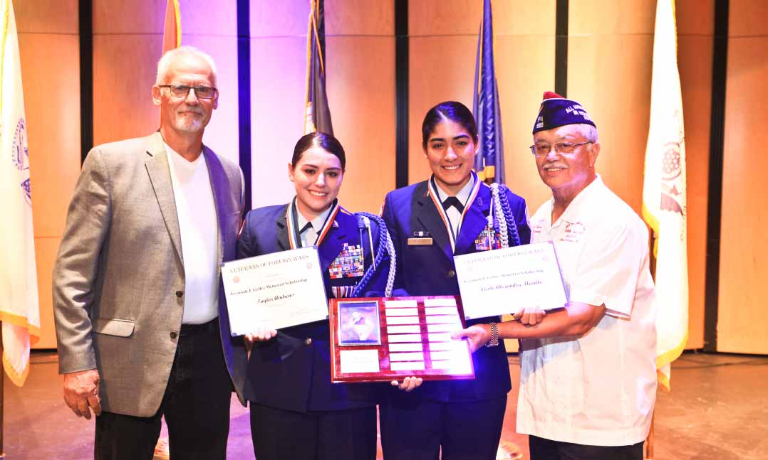 Members of the VFW present service members with a scholarship