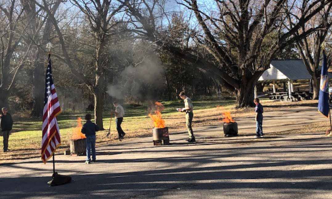 Members of the VFW teach Boy Scouts to properly retire a flag