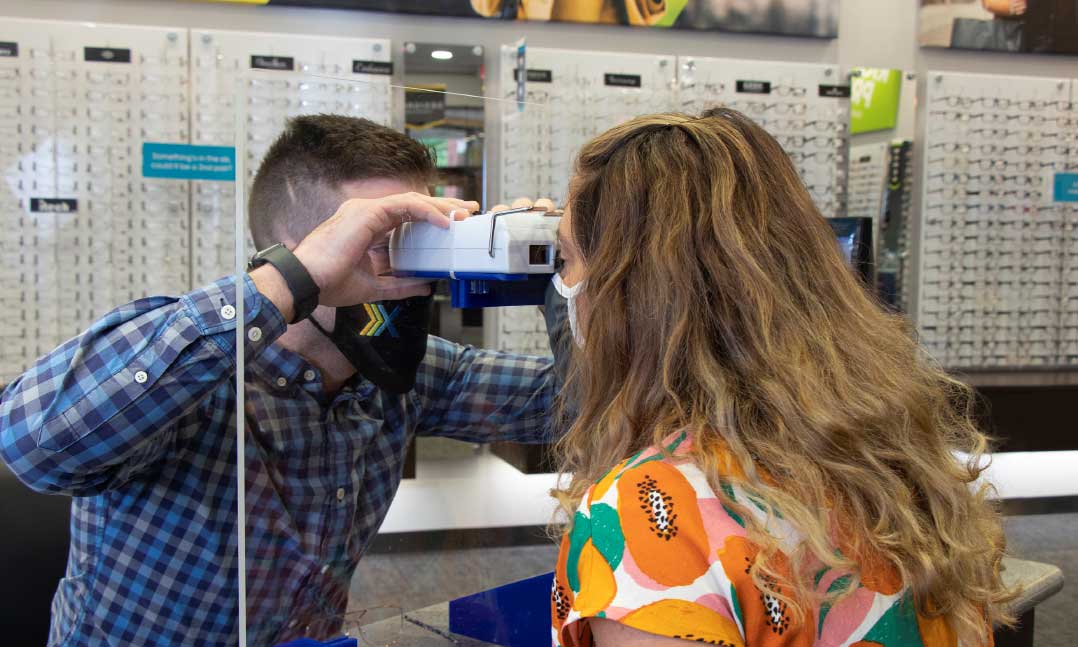 An eye doctor checks the vision of a woman