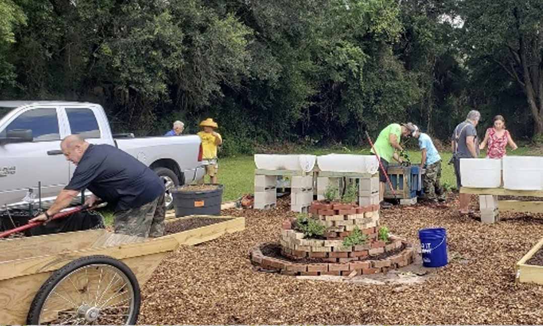 People spend time working in a garden