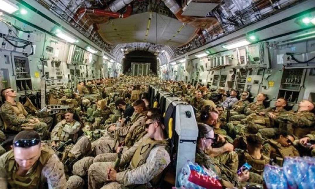 Troops of the 24th Marine Expeditionary Unit fly to Hamid Karzai International Airport