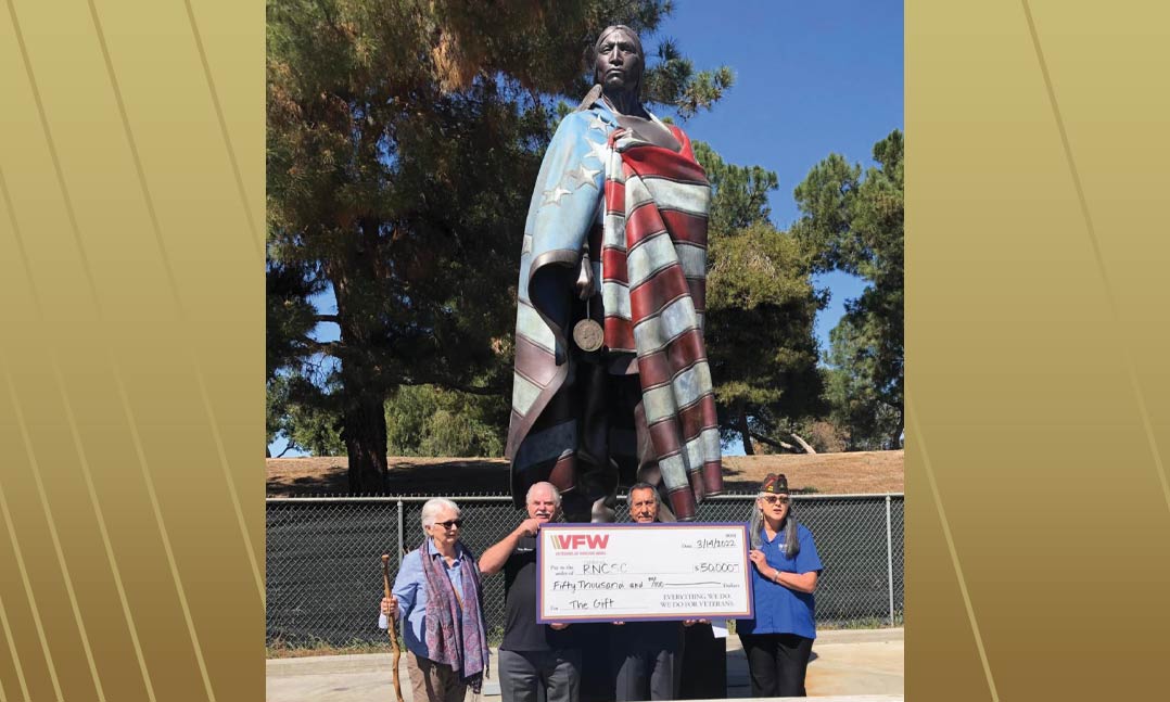 Past VFW Department of California Commander Dawn Napier, far right, presents a $50,000 check in March to members of the Riverside National Cemetery Support Committee in Riverside, Calif., for the American Indian Veterans Memorial