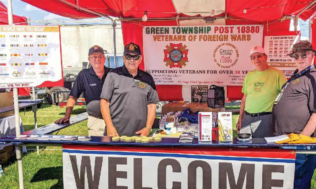 Joe Siebenburger, Tim Burda, Ed Murphy and Roger Giblin of VFW Post 10380 in Green Township, Ohio, man a VFW booth