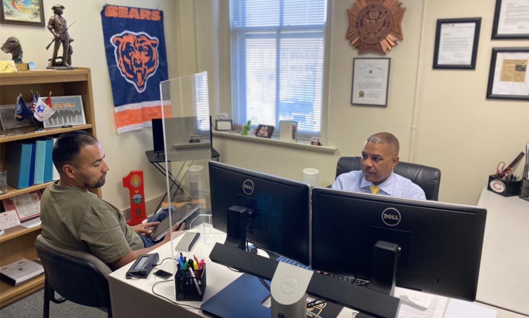 VFW Pre-Discharge Claims Representative Brian Coleman assists a soldier in October at his office at Ft. Riley, Kansas.