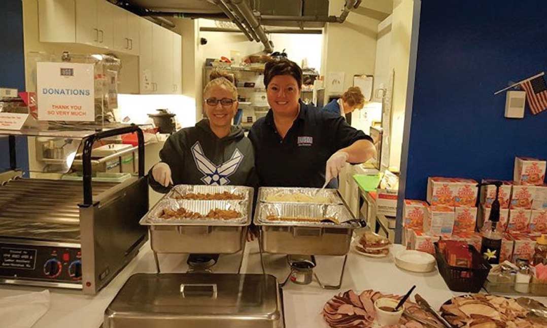 Two VFW members volunteer serving food