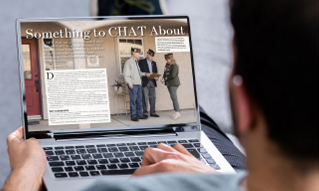 man looks at a digital magazine on his laptop