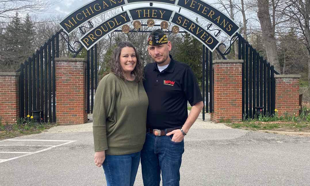 VFW and VFW Auxiliary member stand in front of a Michigan veterans cemetery