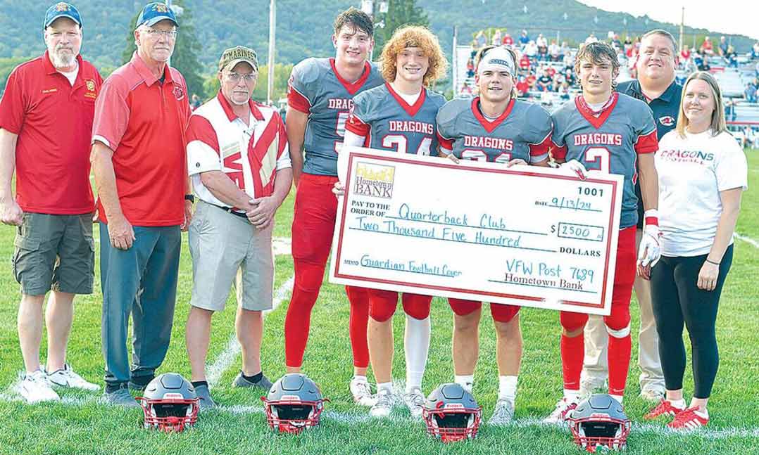 Representatives of VFW Post 7689 in Martinsburg, Pennsylvania, present a $2,500 check to members of the Central High School football team