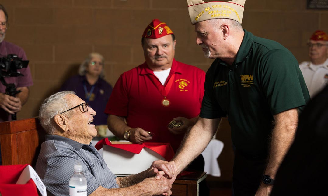 VFW Department of Arizona Senior Vice Commander Gregory Harrell (right) greets Robert Brutinel (left) on Aug. 31 for the World War II veteran’s 100th birthday celebration