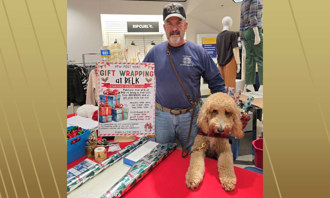 VFW Post Commander Buck Bennett, with his service dog, Ginger, prepares to wrap presents at Belk department store in Brunswick, Ga.