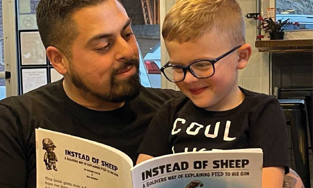 Mathius Carter watches his son read from “Instead of Sheep: A Soldier’s Way of Explaining PTSD to his Son”