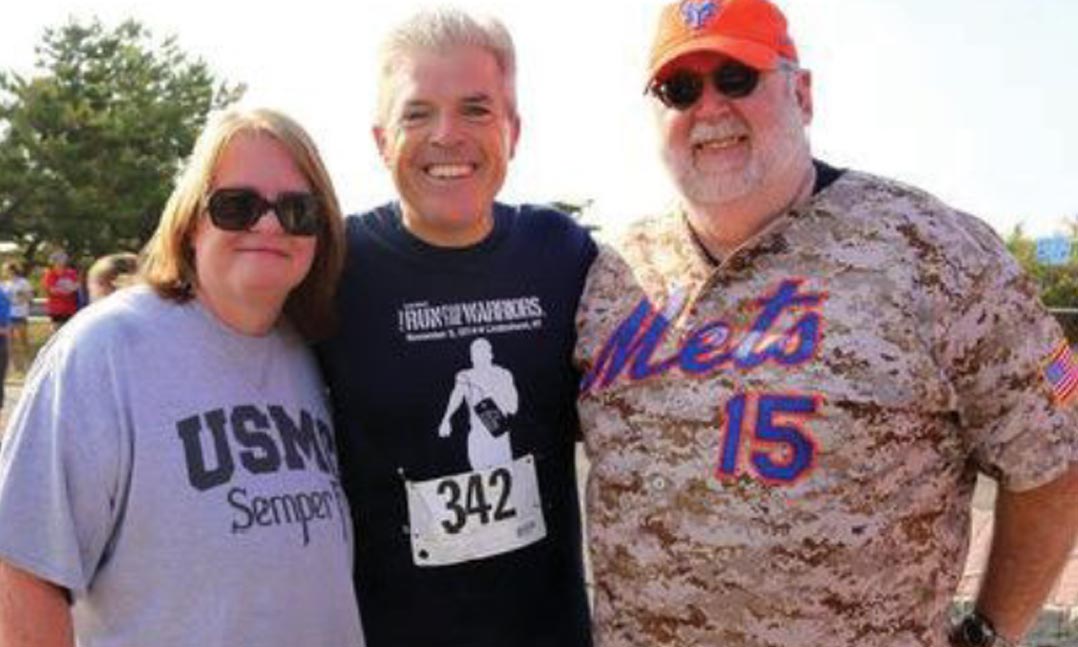 Gold Star parents Janet and Tim Scherer visit with then-County Executive Steve Bellone, center