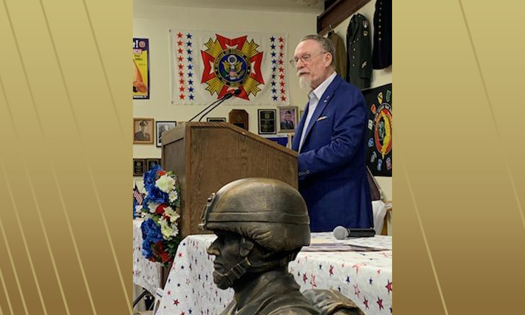 Veteran speaking at podium during Vietnam War Veterans ceremonial dinner