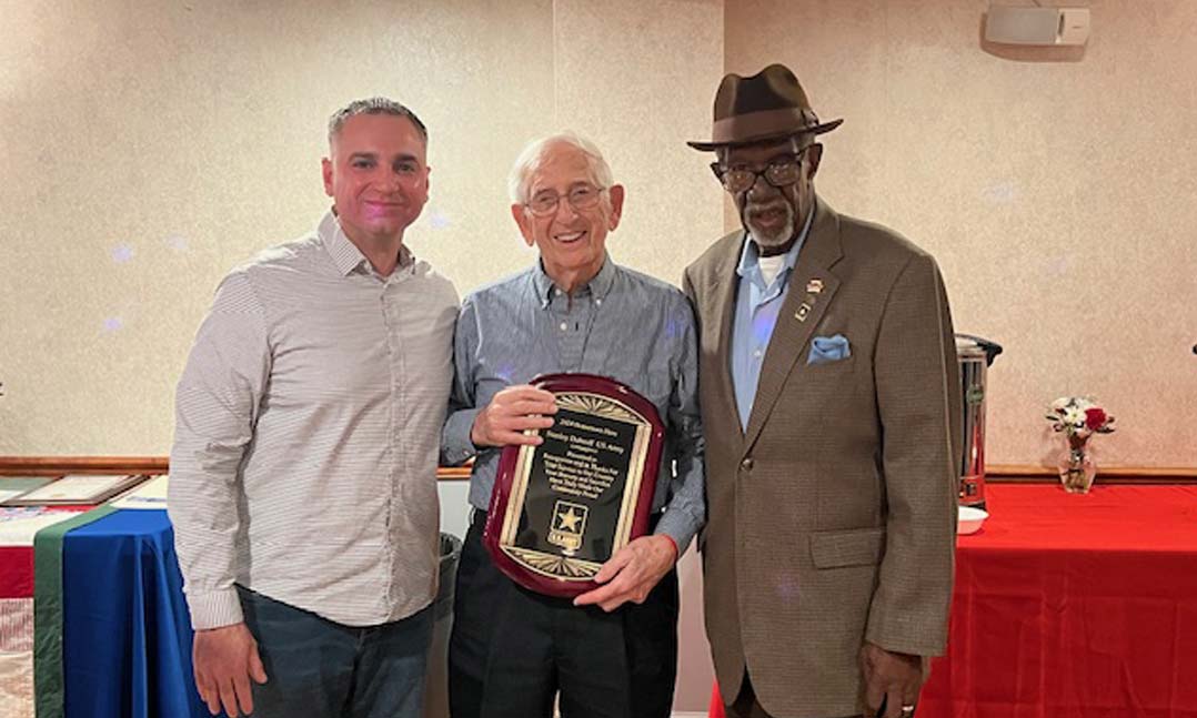 World War II veteran Stanley Dubroff, center, accepts the 2024 Neptune Township/VFW Hometown Heroes Award on April 20 from VFW Post 1333 Jr. Vice Commander Anthony Gualario, left, and VFW Post Commander Wilbur Martin at VFW Post 1333 in Neptune, N.J.