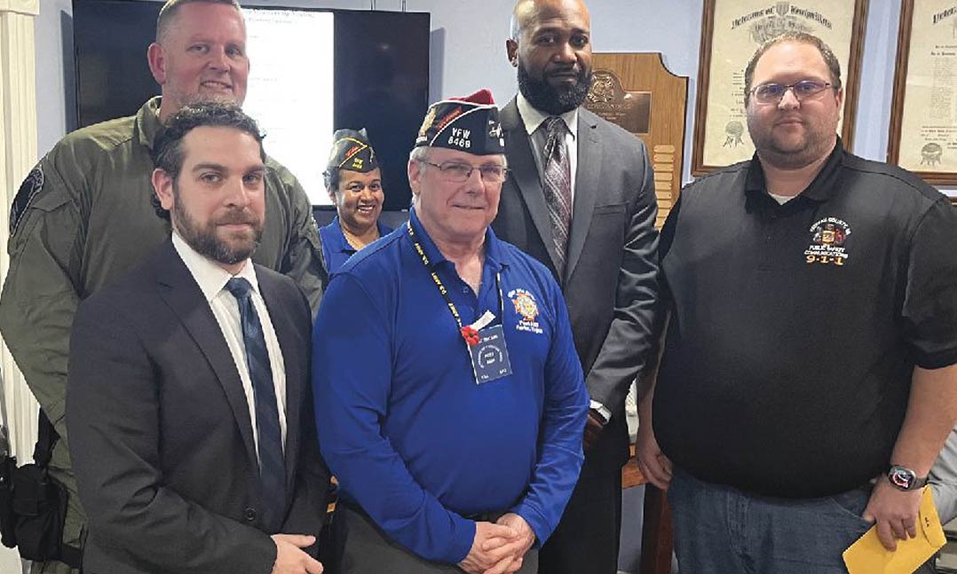 VFW Post 8469 Commander James McCarl, center, stands with the four local VFW Public Servant Award recipients on March 4 at VFW Post 8469 in Fairfax, Va.