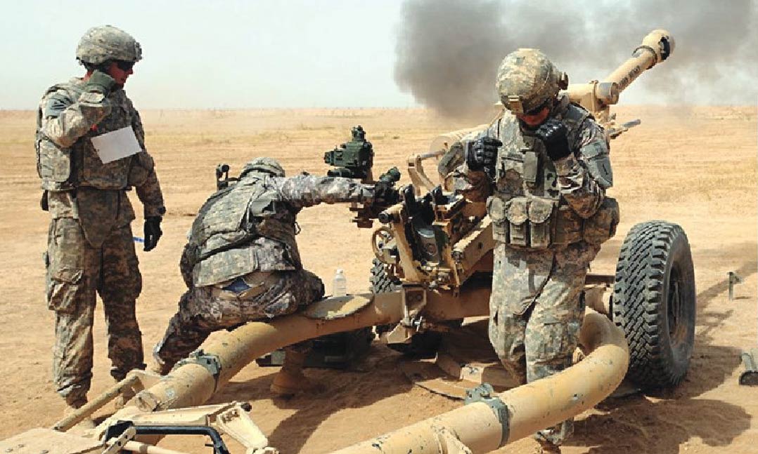 Army Howitzer crewmembers of 2nd Bn., 32nd Field Arty Regt., 4th Inf. BCT, 1st Inf. Div., fire a round