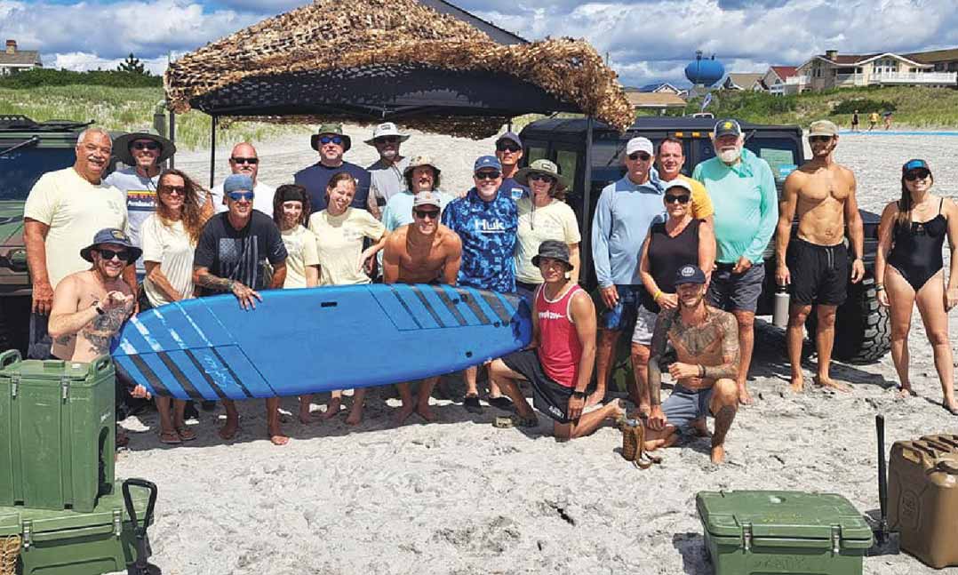 Veterans, participants and collaborators join in celebrating the first-ever Brig-Vet Surf Camp at Brigantine Beach in Brigantine, N.J., in July 2022.