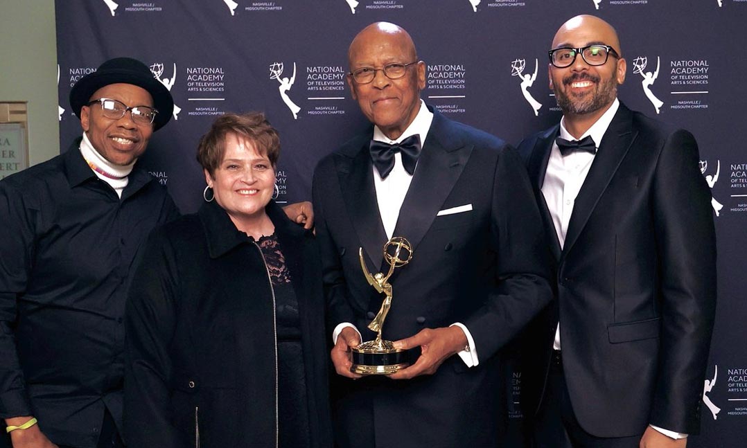 VFW life member Henry Hooper, center, holds an Emmy Award presented to the Lt. Col. Luke Weathers Jr. VA Medical Center’s Public Affairs Office