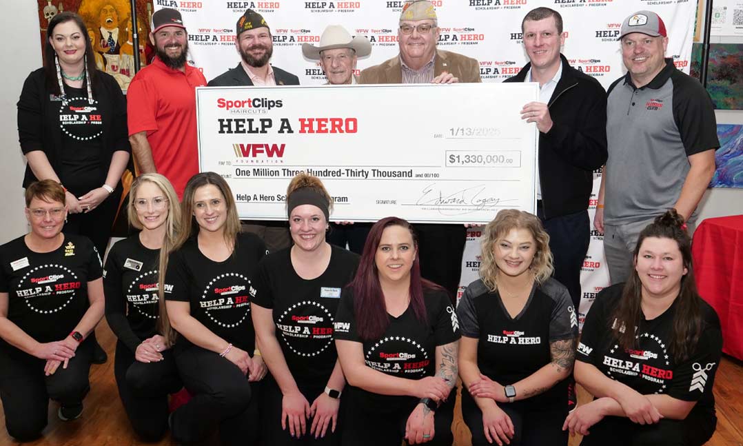 Sport Clips leaders accept a $1.33 million check from Sport Clips Haircuts leaders, supporters and stylists