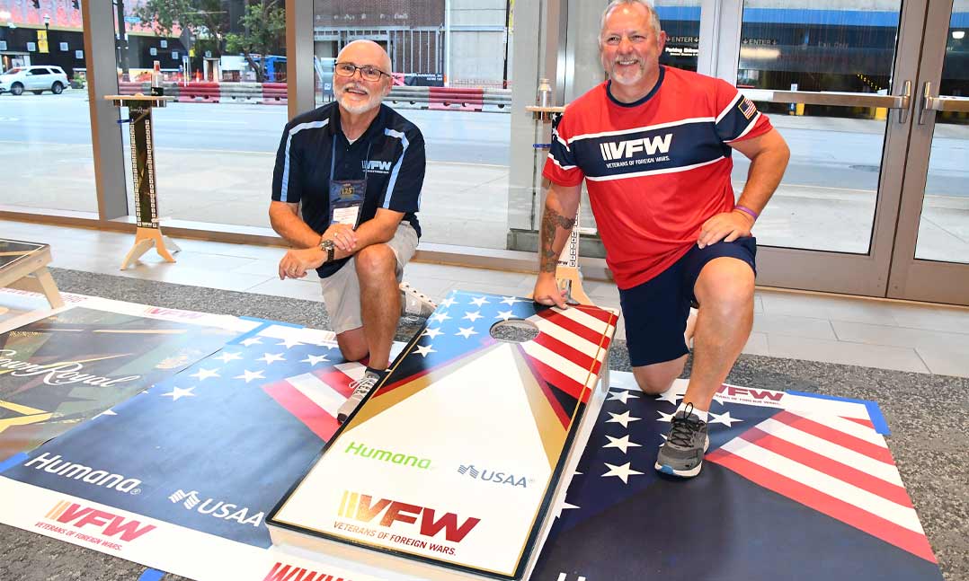 Former VFW Adjutant General Kevin Jones, left, and Chris Haynes from VFW Post 7596 in Franklin, Ohio, take a break last July during the second annual Cornhole Tournament