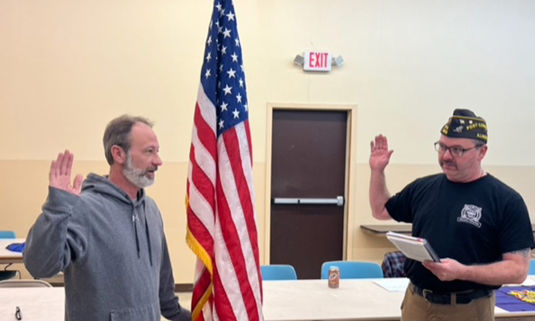 Post 11019 Commander Tom Dummer swears in new Post member Cliff Strong