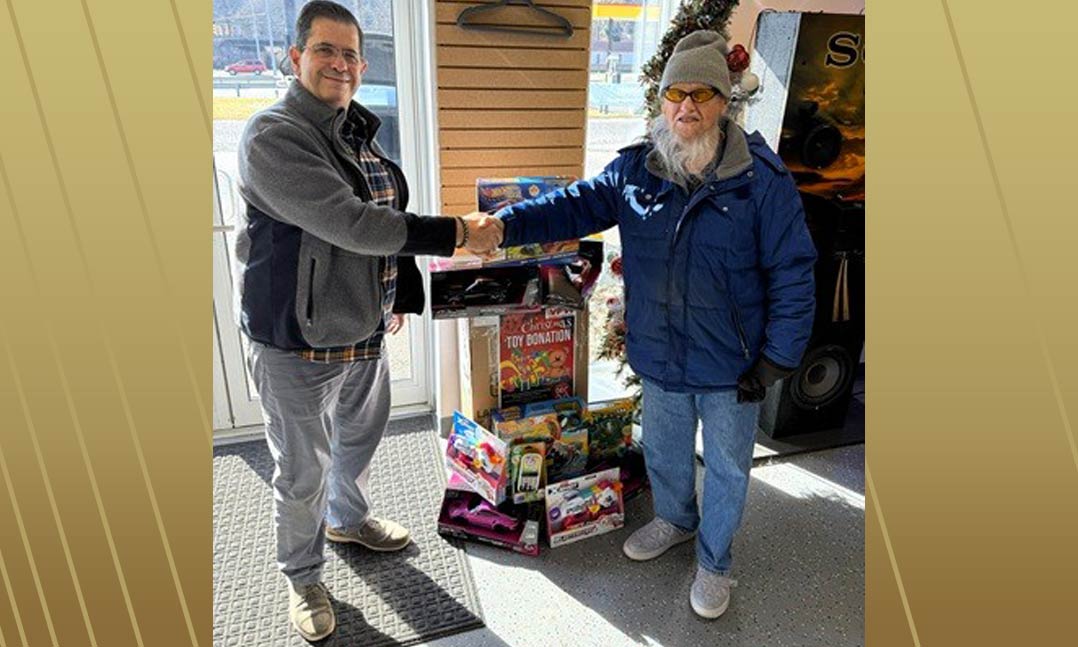 VFW Post 6418 Commander Post Commander Gerald “Jerry” Mollohan, right, collects Christmas toys