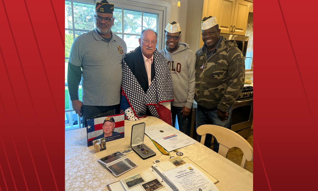 VFW Post 1790 leaders award Alfred Bosco, center, a Quilt of Valor during a ceremony at his home on April 9 in Valley Stream, N.Y.