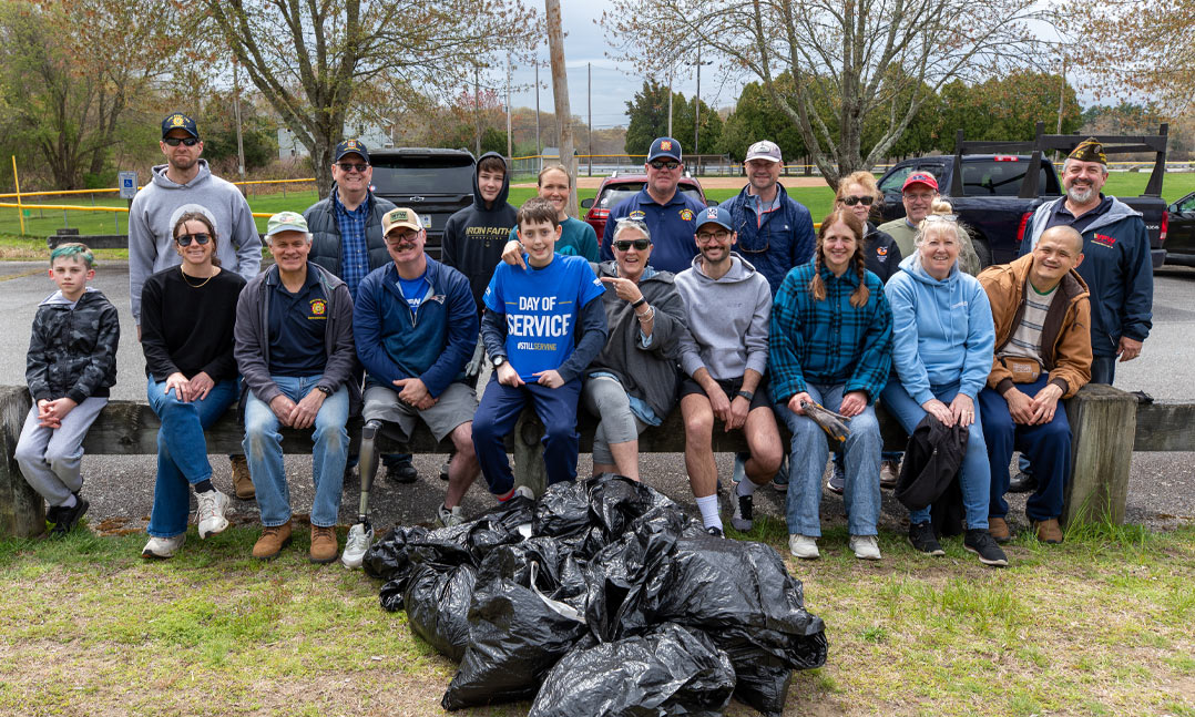 Members of VFW Post 152 in North Kingstown, R.I., gather with volunteers following a VFW Day of Service park cleanup event