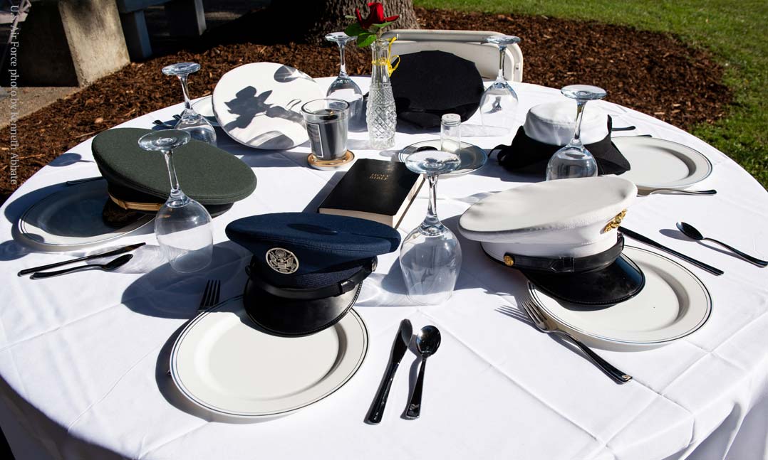 Missing Man POW/MIA table with service hats from all military branches