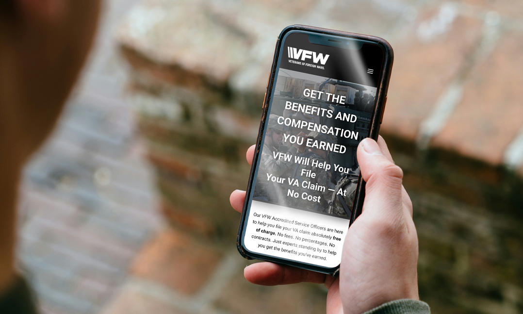 hand holding phone looking at redesigned claims.vfw.org to streamline VFW's VA claims assistance